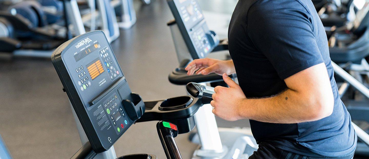 A person working out on cardio equipment at the Recreation Center.